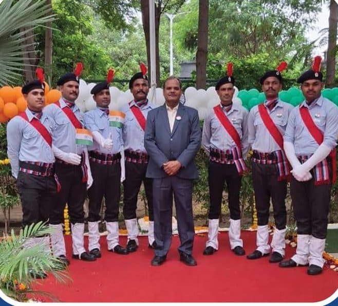 Om Sai guards with management at a ceremony